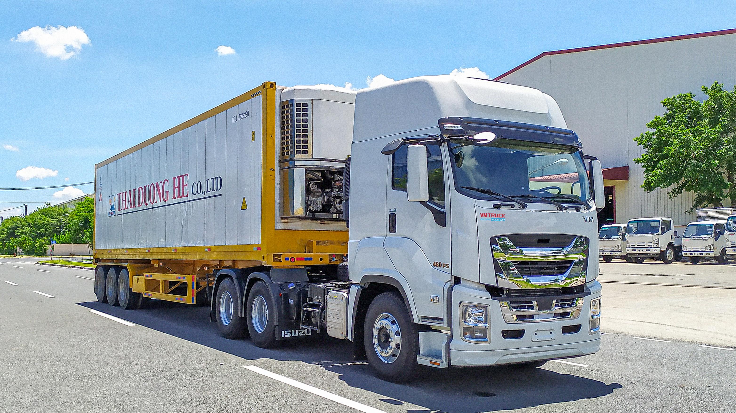 Xe đầu kéo trắng VM TRUCK GINGA Series kéo rơ-moóc thùng kín trên đường.